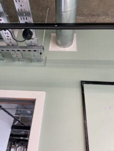 Exposed ceiling ductwork and cable trays indoors